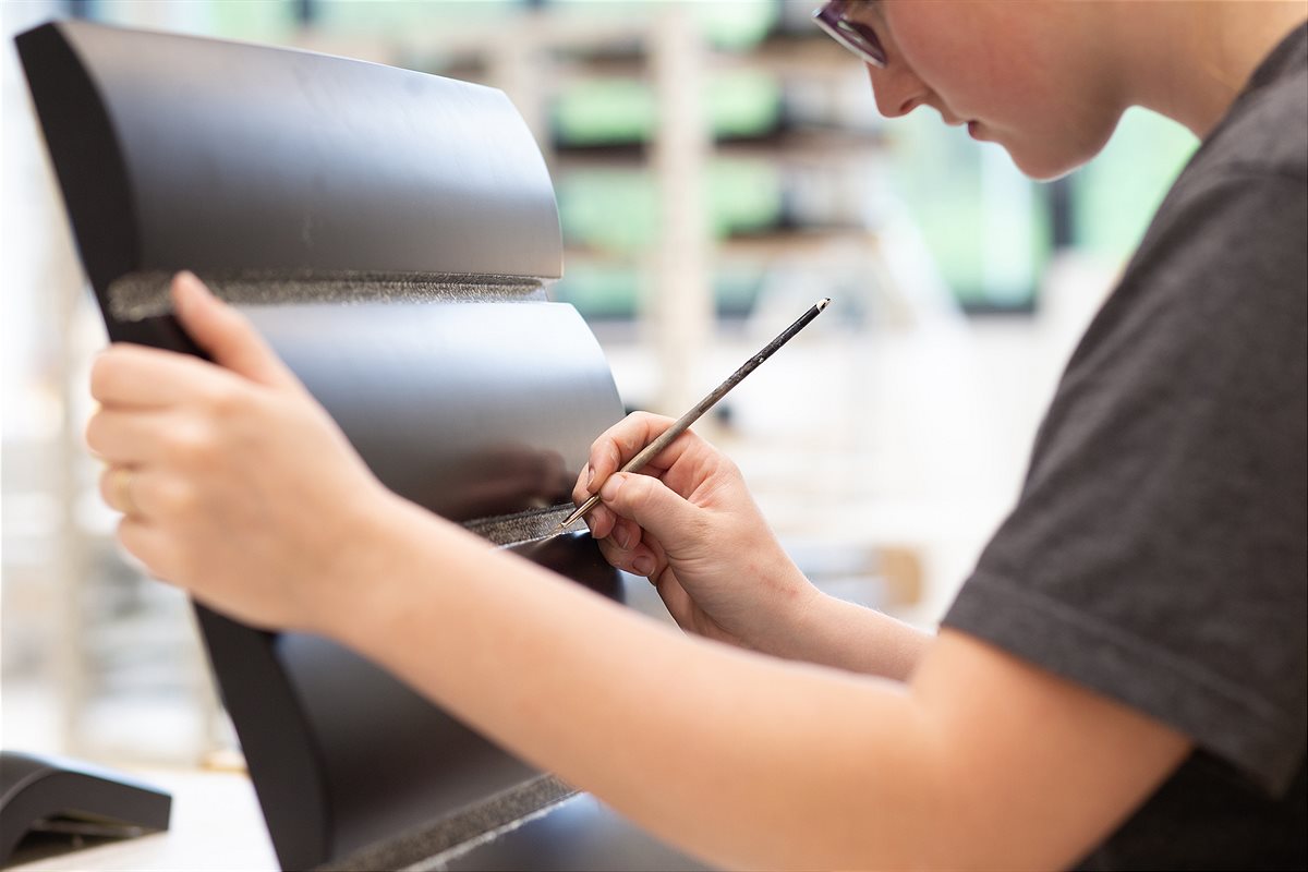 Yvonne Wieser, Absolventin der Meisterschule für Malerei, verfeinert ein Möbelstück